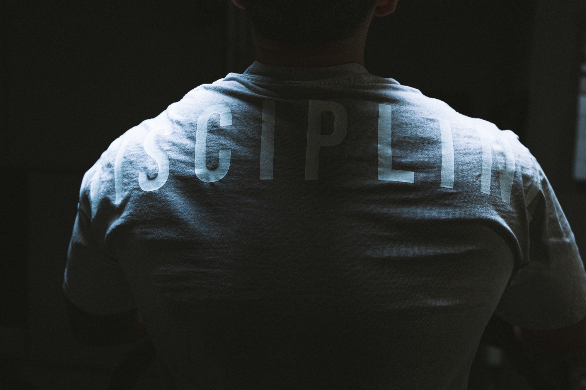 &ldquo;Discipline&rdquo; printed across the back of Elijah's shirt.